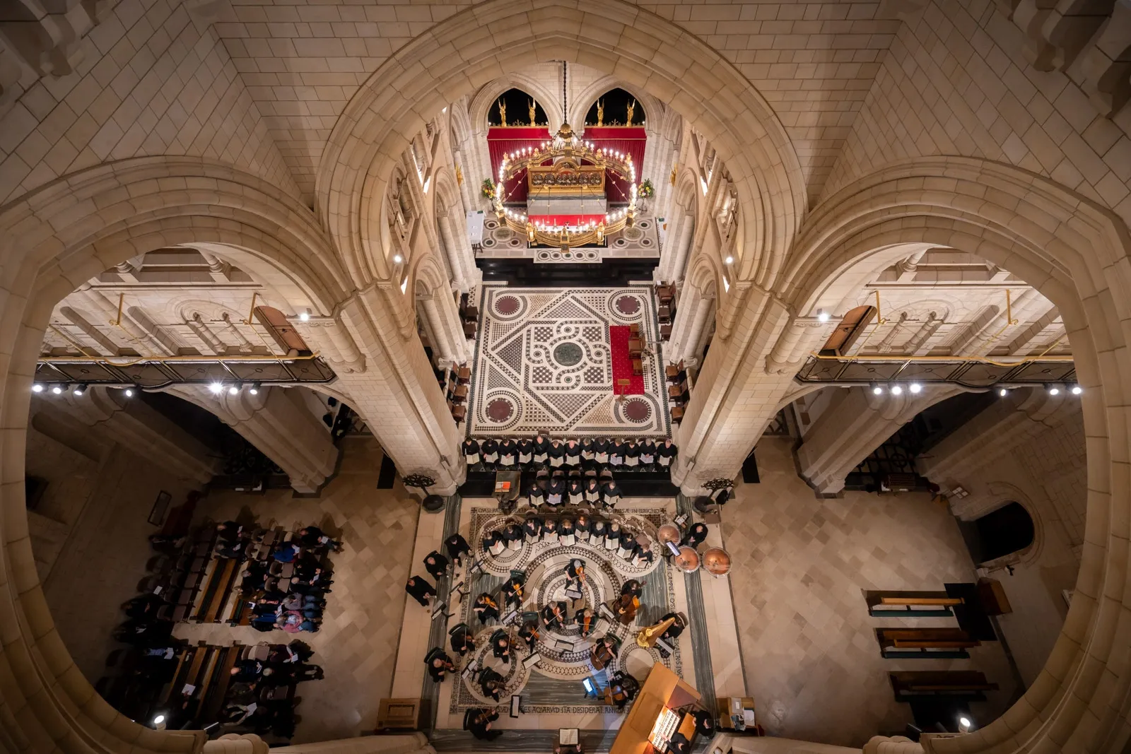 An orchestra performs on the crossing floor of Buckfast Abbey