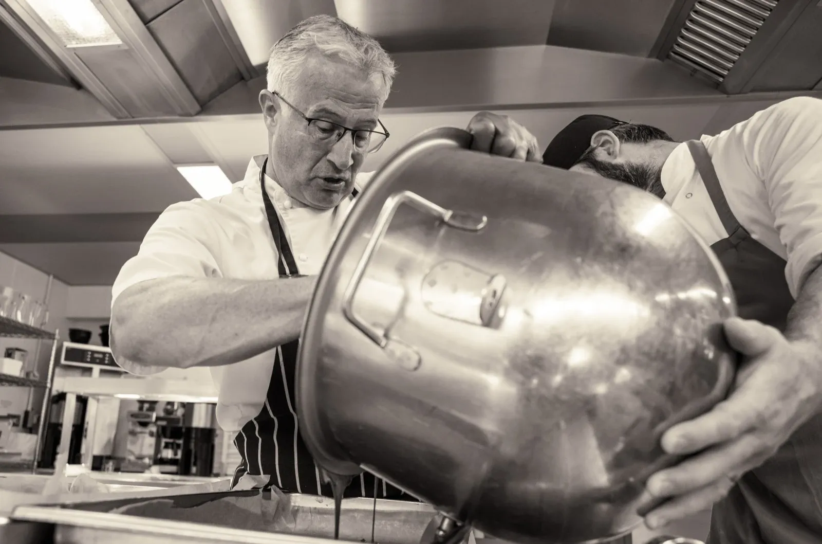 Peter Gorton a Devon chef works with another chef in a kitchen