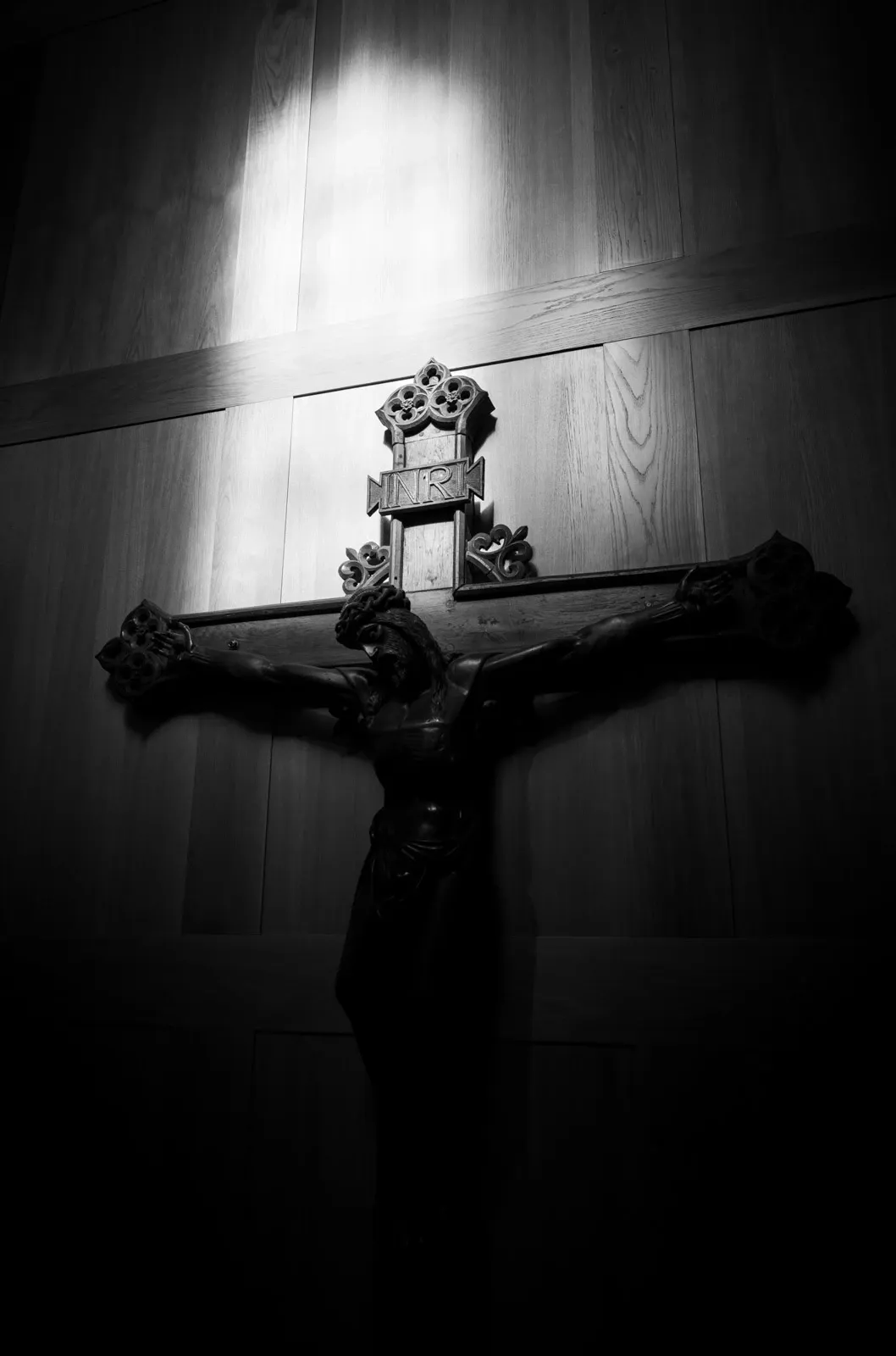 Window light illuminates a large crucifix