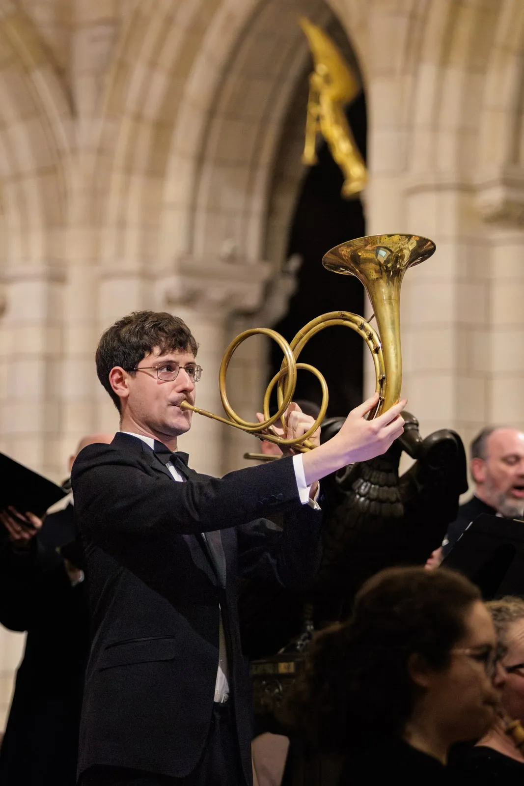 A musician plays a natural horn