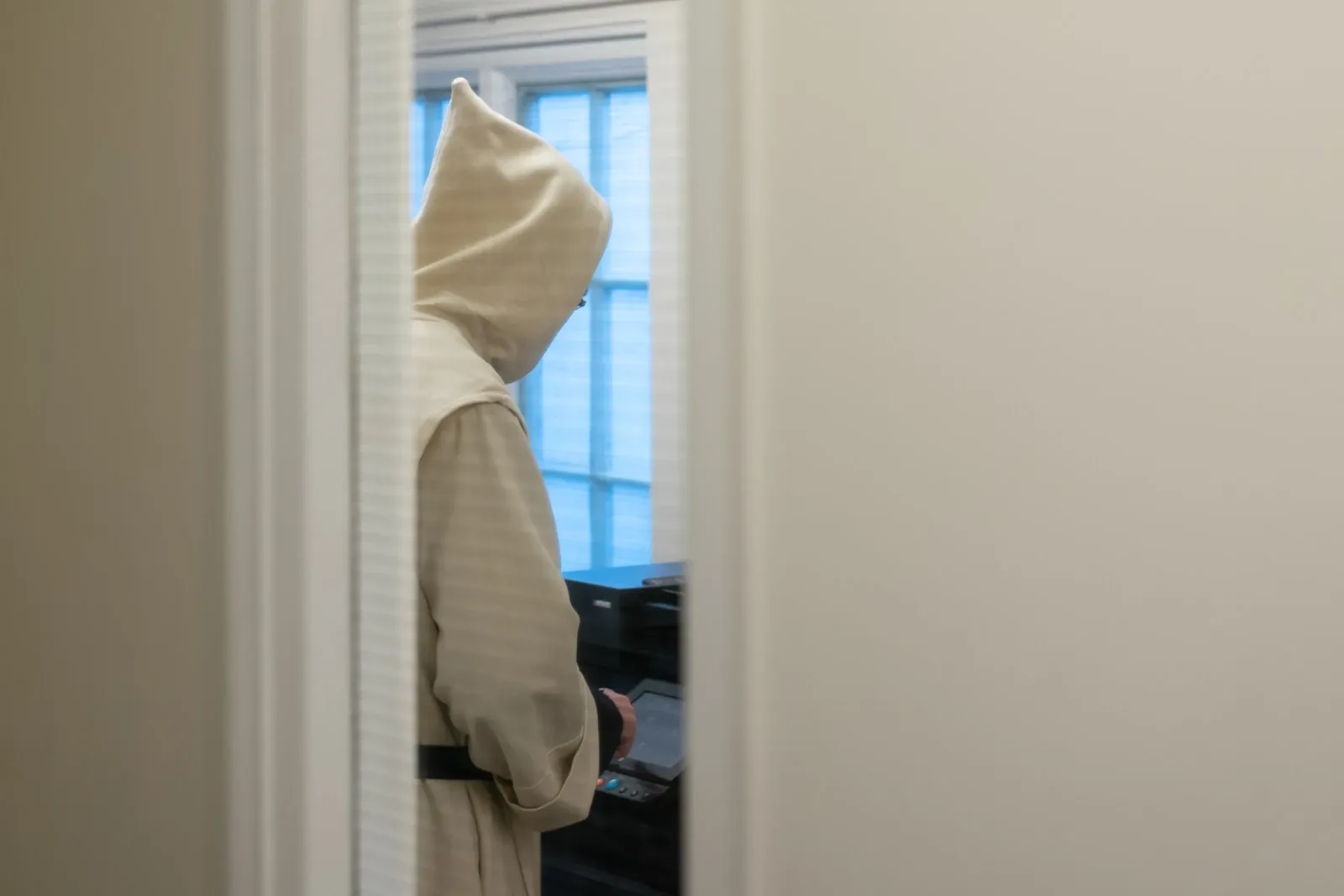 A Carthusian monk uses a printer