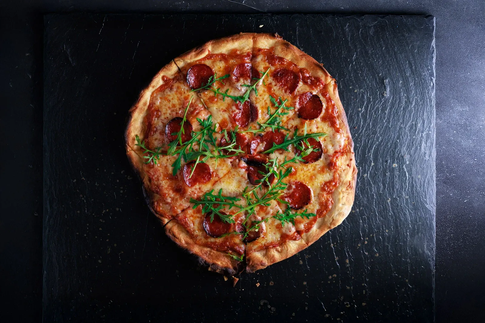 Pepperoni pizza on a slate surface