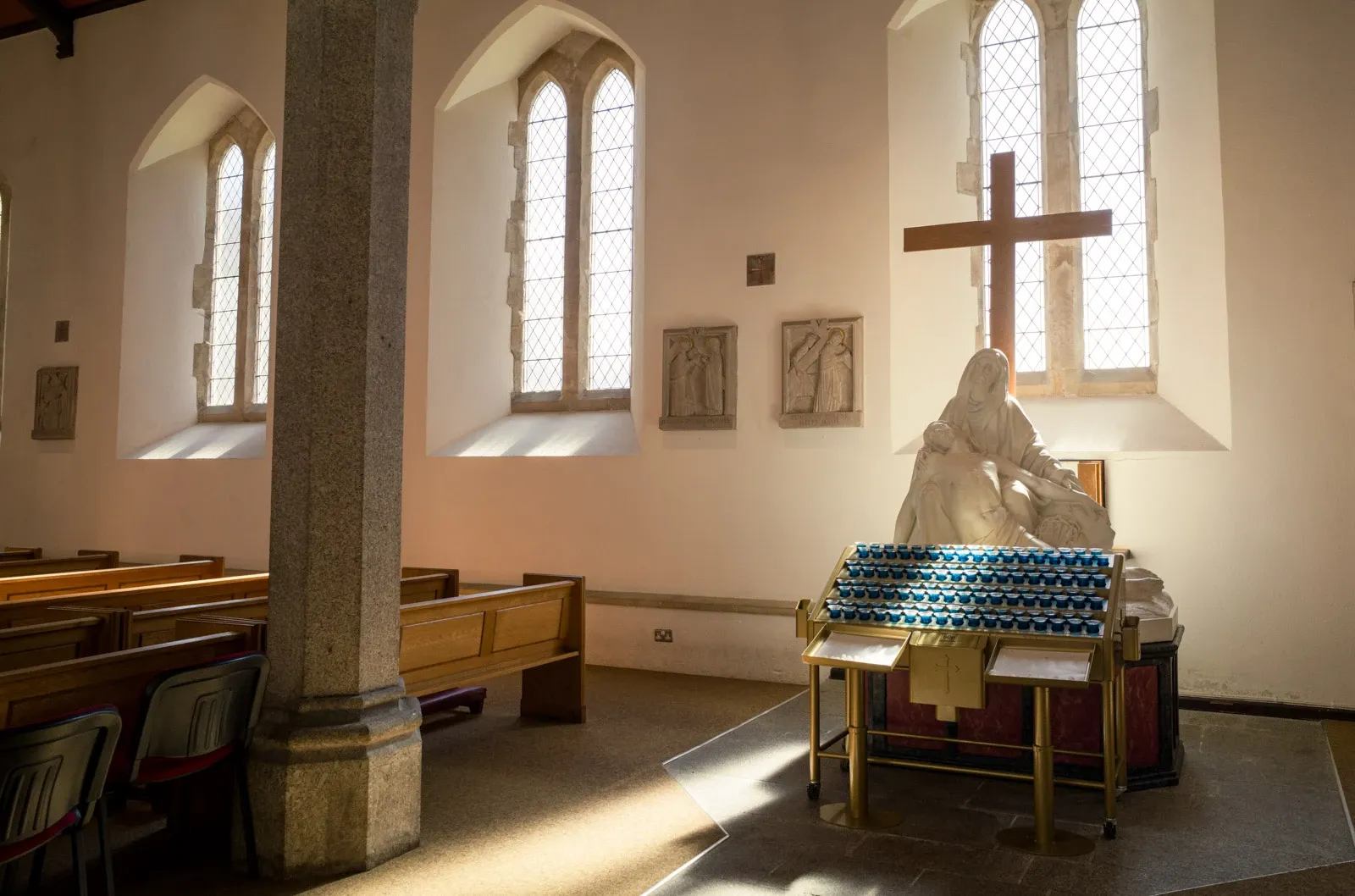Light pours over the Pieta statue inside Plymouth Cathedral
