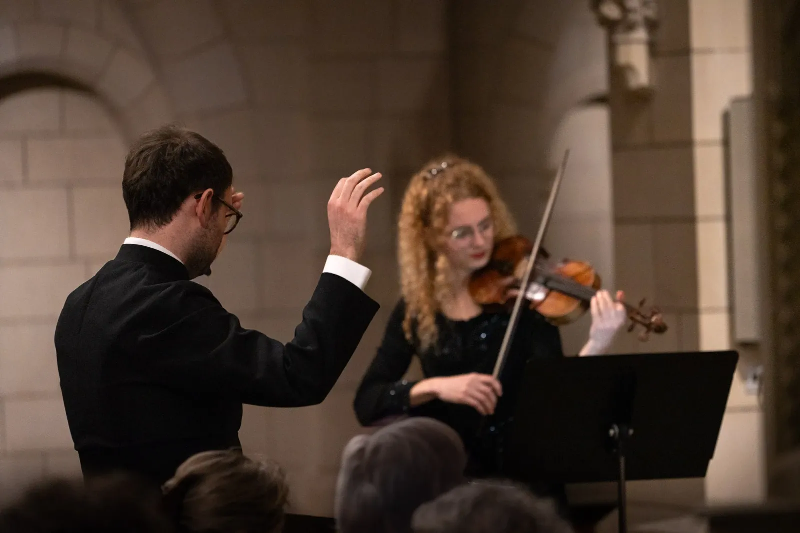 A violinist is directed