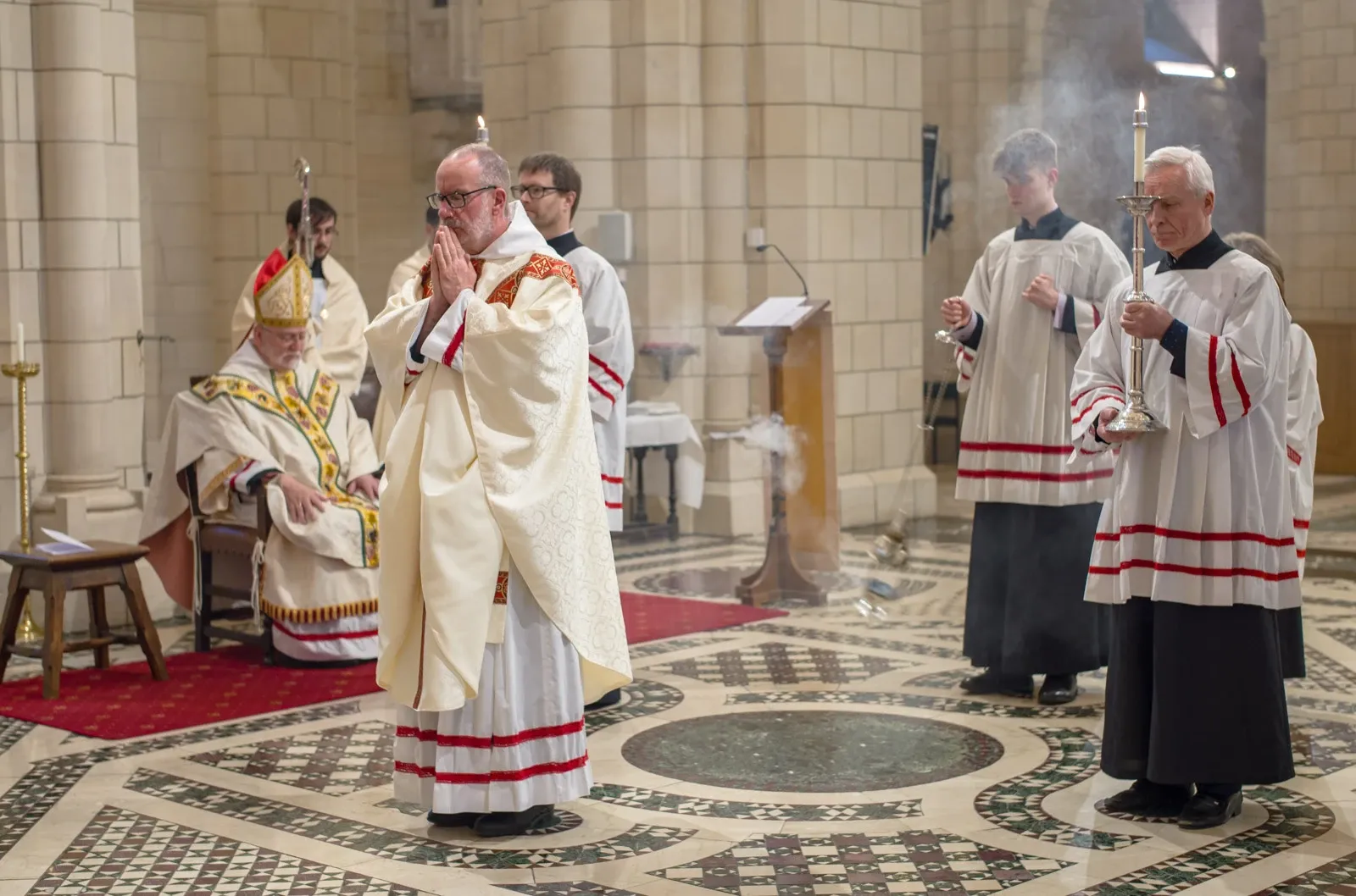 A Priest stands before the Abbot during Mass before reading the Holy Gospel